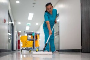 Cleaner mopping the floor in hospital setting